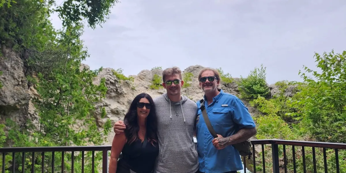 Mike Brandow standing with his wife and son outdoors